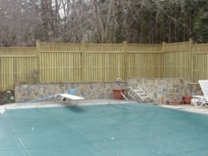 A board-on-board privacy fence design with lattice top