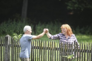 Neighbors greeting each other over fence
