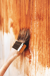 a wood fence being stained